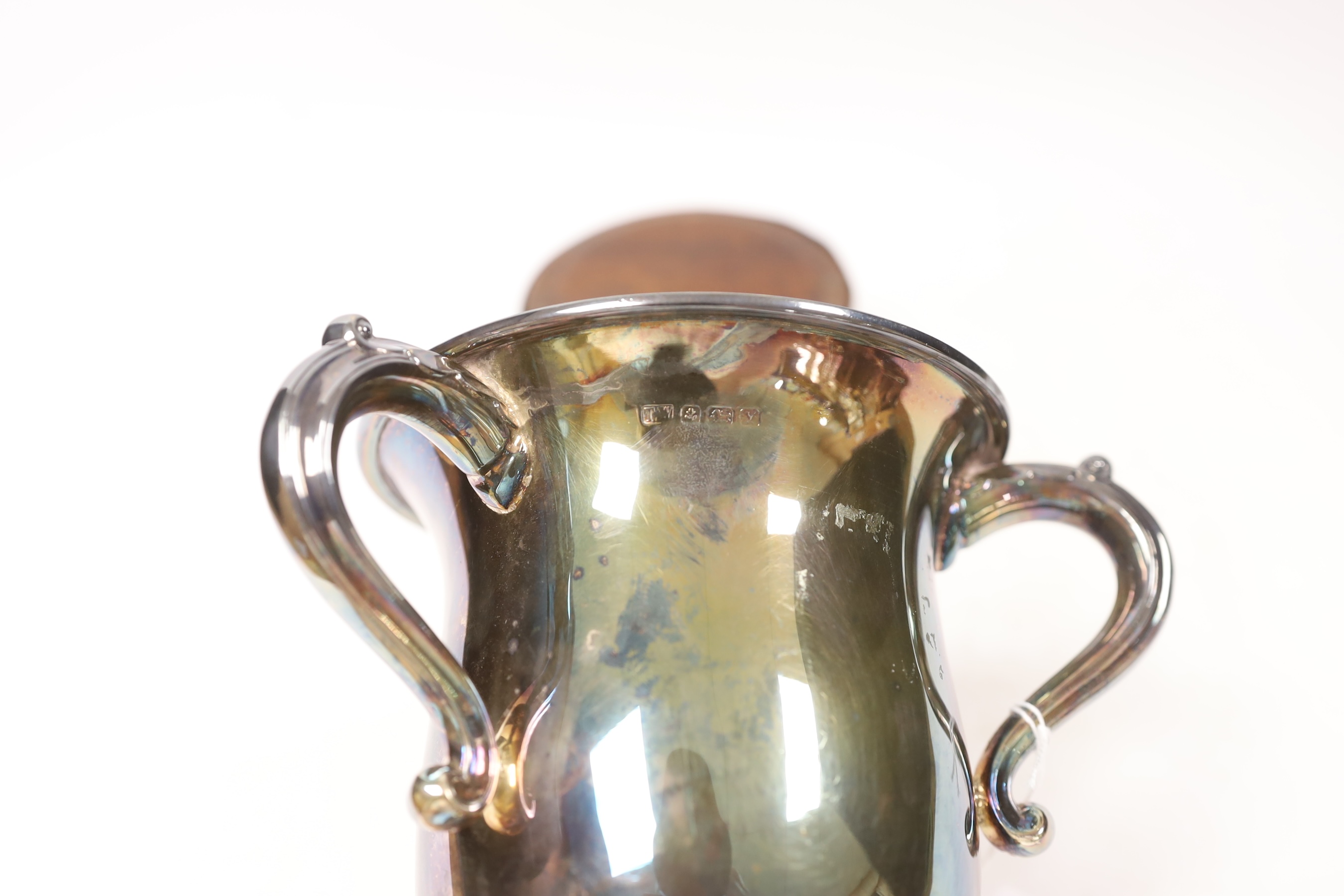 A George V tri handled silver presentation cup, T. Wilkinson & Sons, Birmingham, 1923, height, 18.9cm, 15.1oz, on a circular socle.